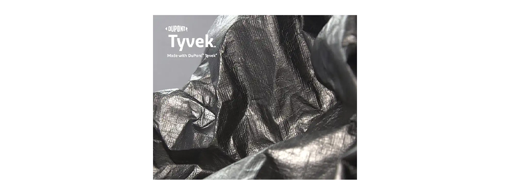 Crinkled black DuPont Tyvek® fabric sample showing natural fold texture for bag production
