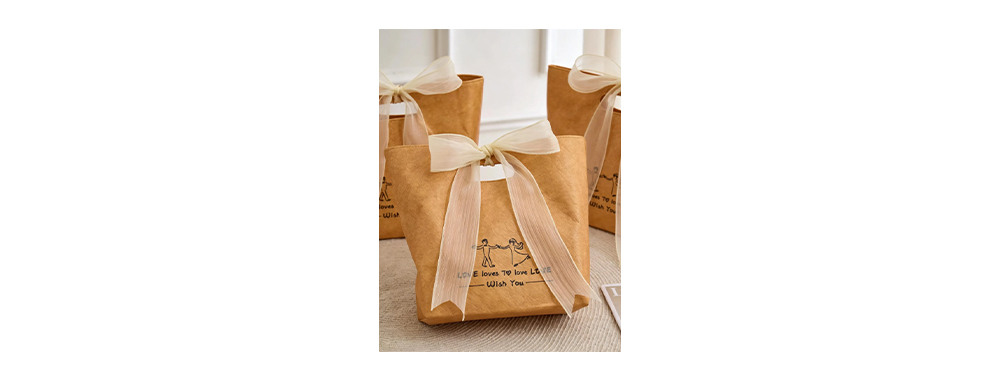 Premium kraft‑toned Tyvek® gift bags decorated with sheer organza ribbon bows